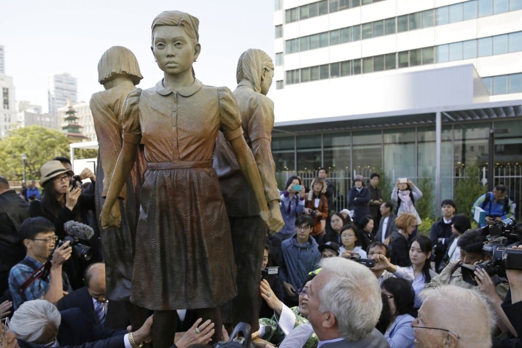 People surround the “comfort women” monument in San Francisco. Photo: AP
