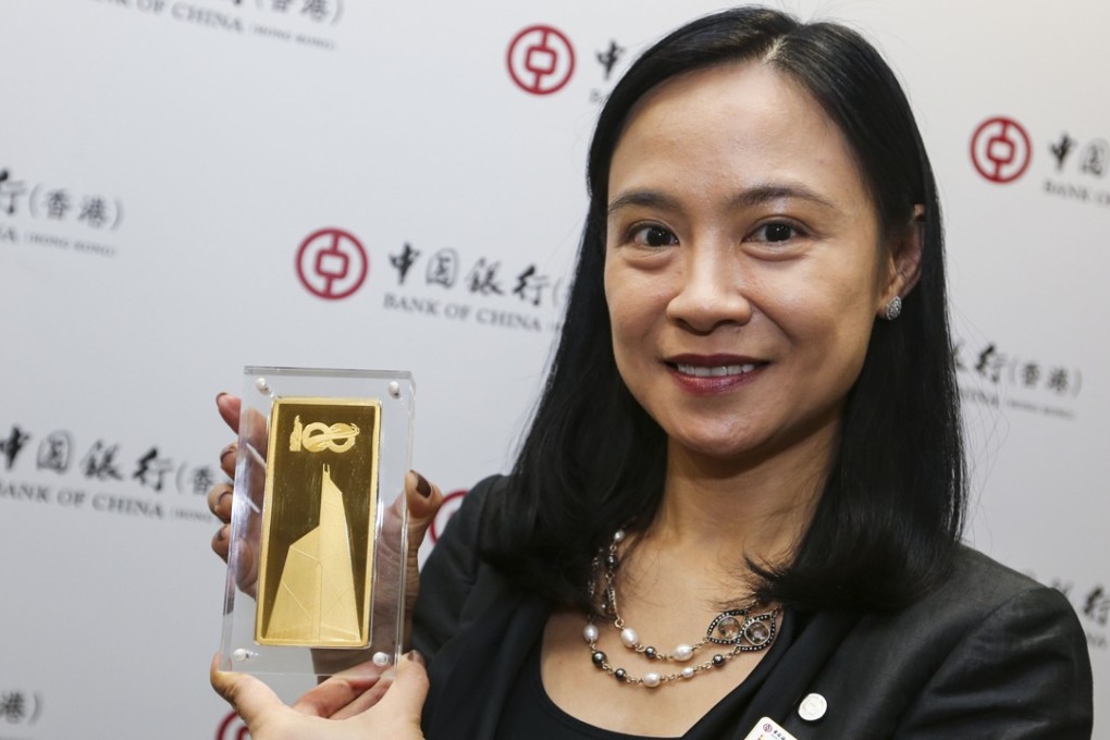 The distinctive image of the Bank of China Tower engraved on the commemorative 1kilo gold bars, being shown here by the bank’s head of treasury product division Winnie Cheung Wing-sze, to mark its 100th anniversary in Hong Kong. The bars are being produced by Swiss gold refiner PAMP, part of MKS PampGroup, and will go on sale from next month. Photo: David Wong
