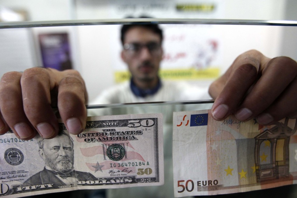A worker displays US dollar and Euro notes at a money exchange company in Peshawar, Pakistan. The dollar was strong early on Tuesday, September 26, but then faded. Photo: EPA