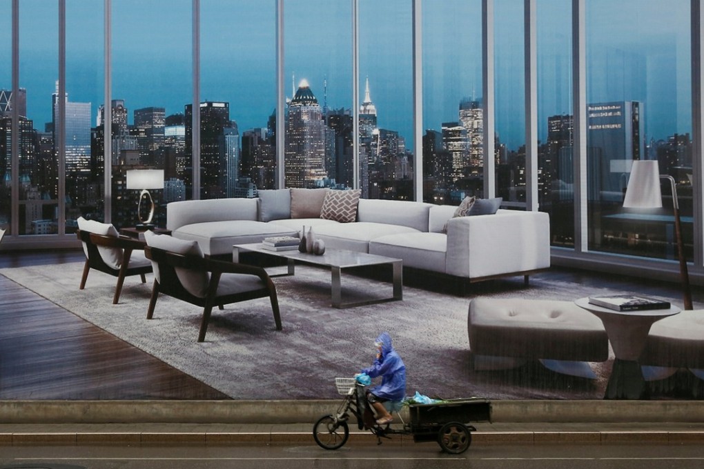 A man rides a tricycle past an advertising poster for luxury apartments in Beijing in July last year. Property ownership is now increasingly what separates the rich and the poor in China. Photo: Reuters