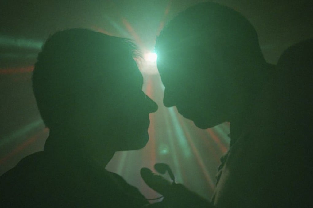 Two men are pictured chatting in a gay disco, in a still from the Vice documentary “Chemsex”.
