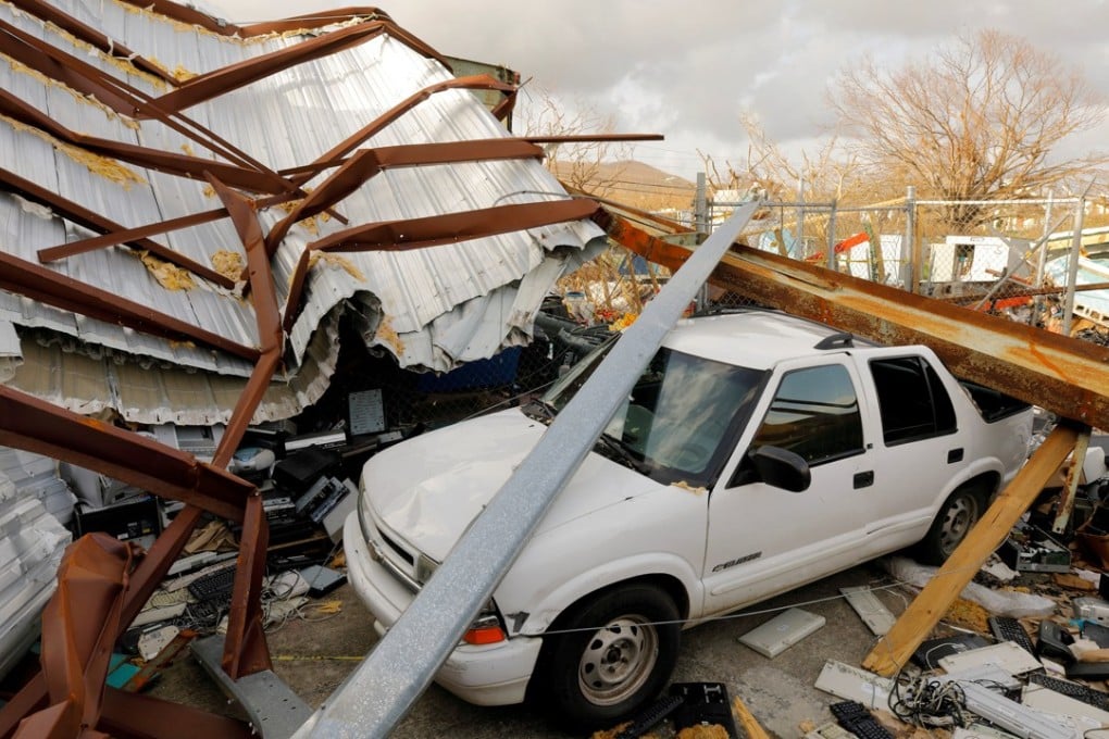 A car is seen crushed by steel beams and roofing that was mangled in the aftermath of Hurricane Maria in the US Virgin Islands. Photo: Reuters