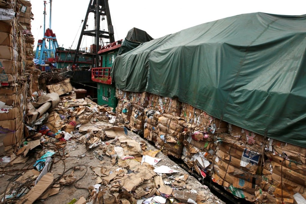 Tonnes of waste paper to be shipped to mainland China pile up at a dock in Hong Kong. Photo: Reuters
