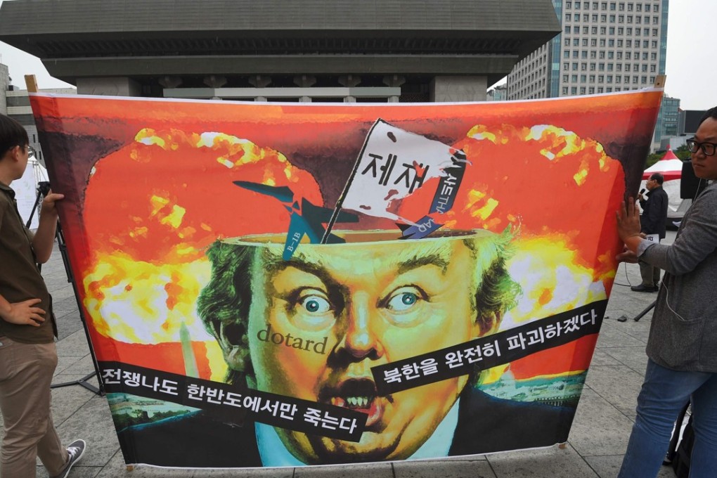 Anti-war activists hold a banner showing a caricature of US President Donald Trump during a rally near the US embassy in Seoul on September 27. Part of the banner reads, “If war breaks out, only those on the Korean peninsula will die”. Photo: AFP