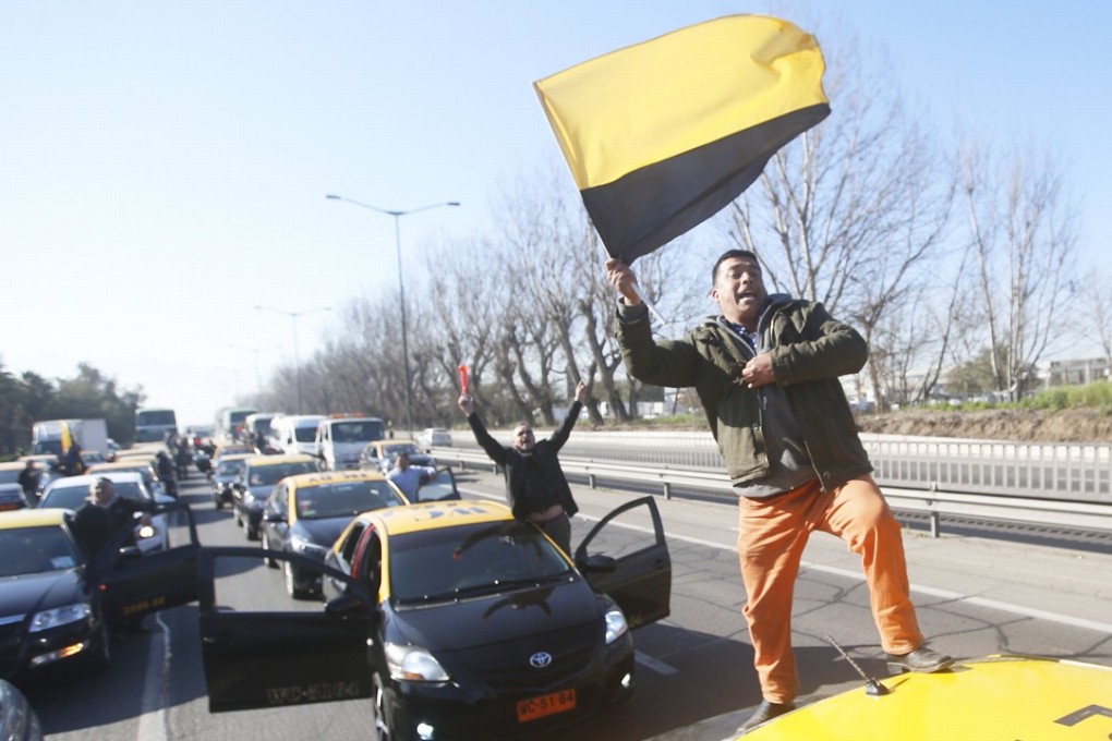 Taxi drivers block the access to the airport, during a protest in Santiago, Chile against the operation of the companies Uber and Cabify in the country. Ride-sharing companies are facing huge growth potential, and significant backlash, worldwide. Photo: EPA