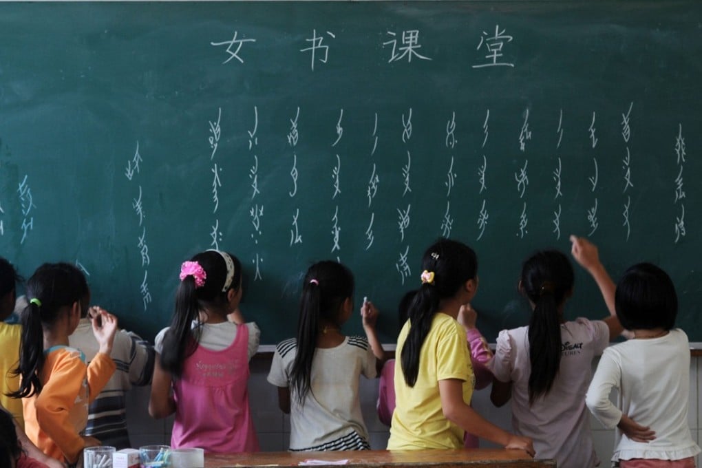 Elementary school students practise writing the Nushu script in Hunan province. Picture: Xinhua