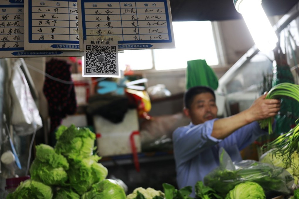 The wide use of mobile payment – by scanning a QR code – has spread to China’s traditional wet markets. Photo: EPA