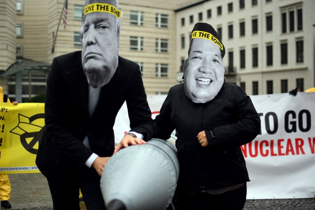 Activists seeking the abolition of nuclear weapons wear masks of US President Donald Trump and North Korean leader Kim Jong-un as they pose with a mock missile, during demonstrations in front of the North Korean embassy in Berlin on September 13. Photo: AFP