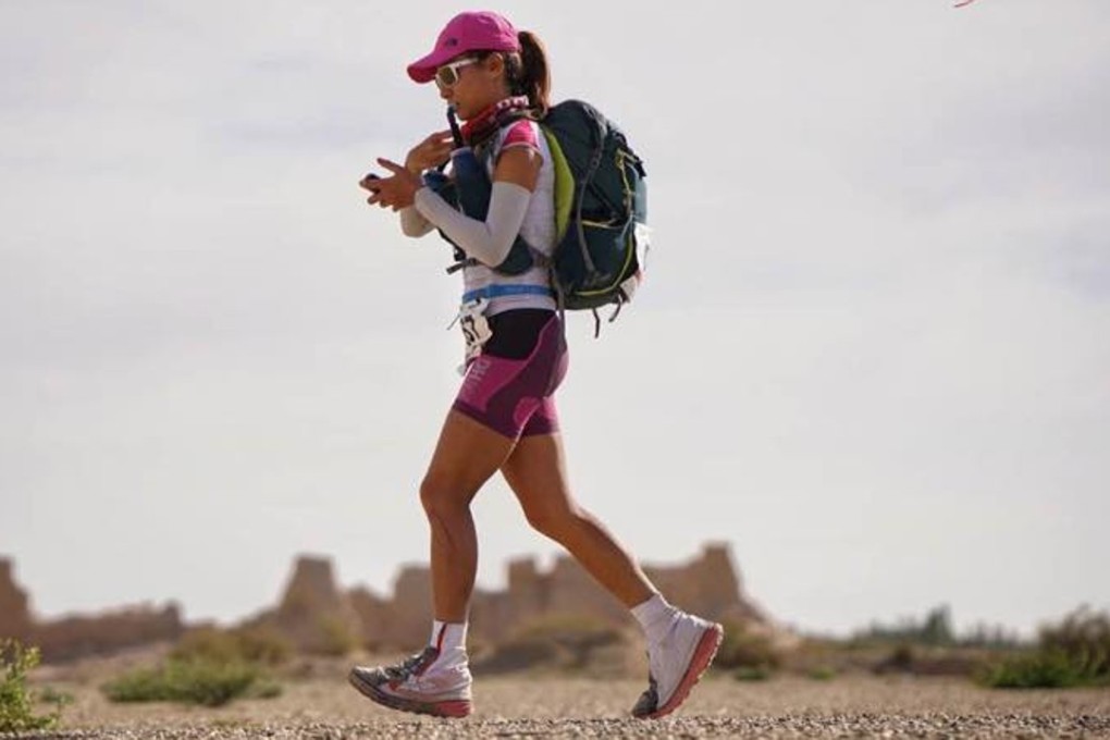 Samantha Chan consults her GPS at 88km into the Ultra Gobi. She is in fourth place and going at a steady pace. Photos: Lloyd Belcher Visuals