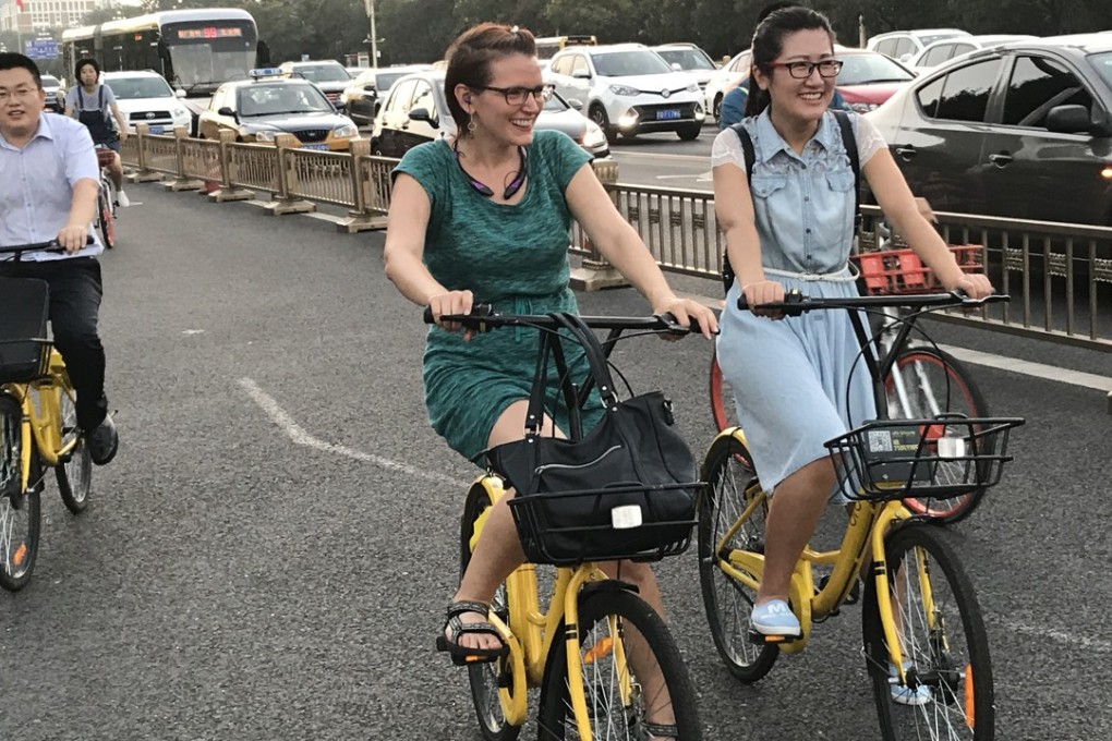 People ride shared bicycles on Chang’an Avenue in Beijing. Photo: Xinhua