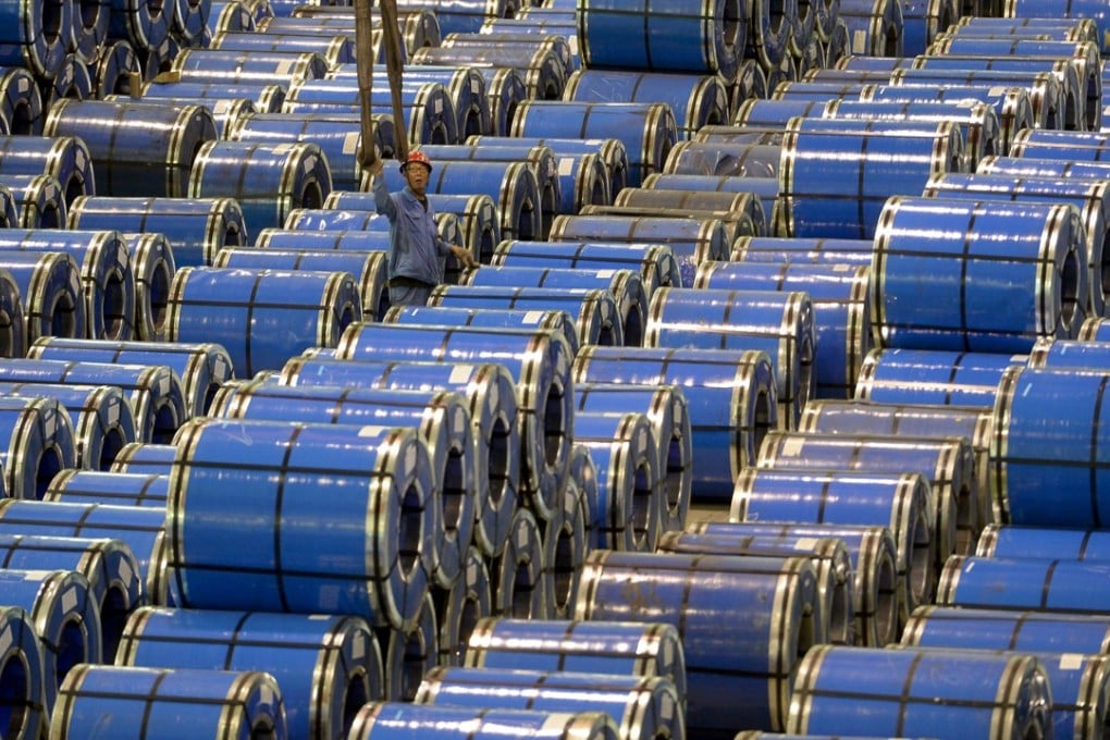 A man works among rolls of stainless steel at a factory in China’s Shanxi province. The US said it will continue its investigations into possible dumping and subsidisation of stainless steel flanges imported from China and India. Photo: Reuters