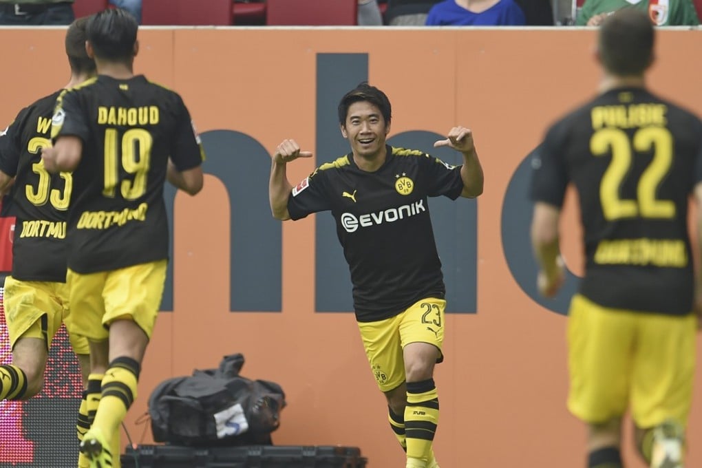 Dortmund's Shinji Kagawa (centre) celebrates his goal against FC Augsburg. Photo: AP