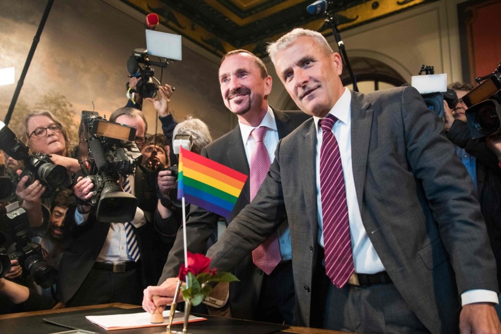Bode Mende and Karl Kreile stamp their marriage certificate as they became Germany's first gay couple to be legally married. Photo: AFP