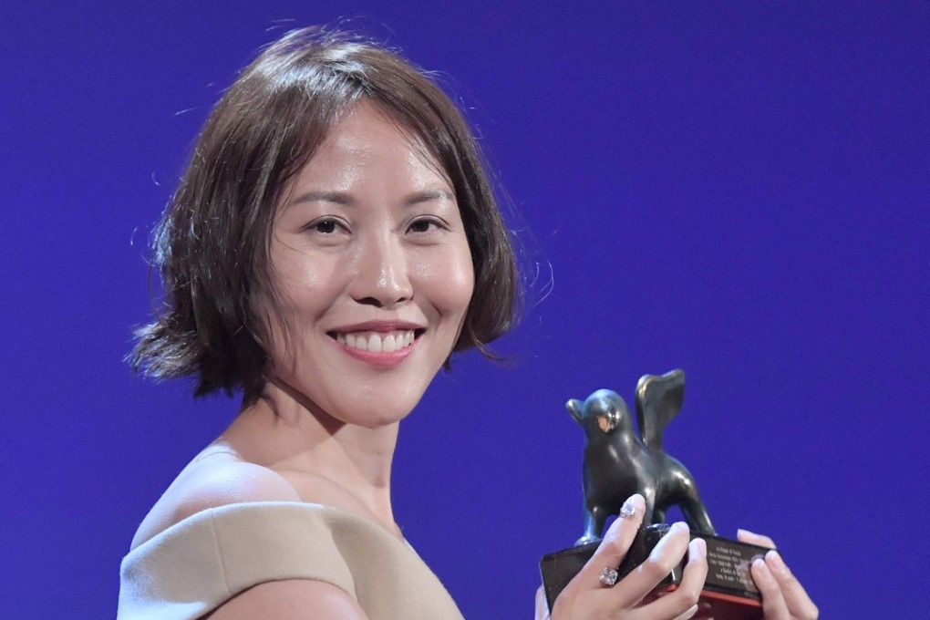 Gina Kim holding the Best VR award for her film Bloodless. Photo: AFP