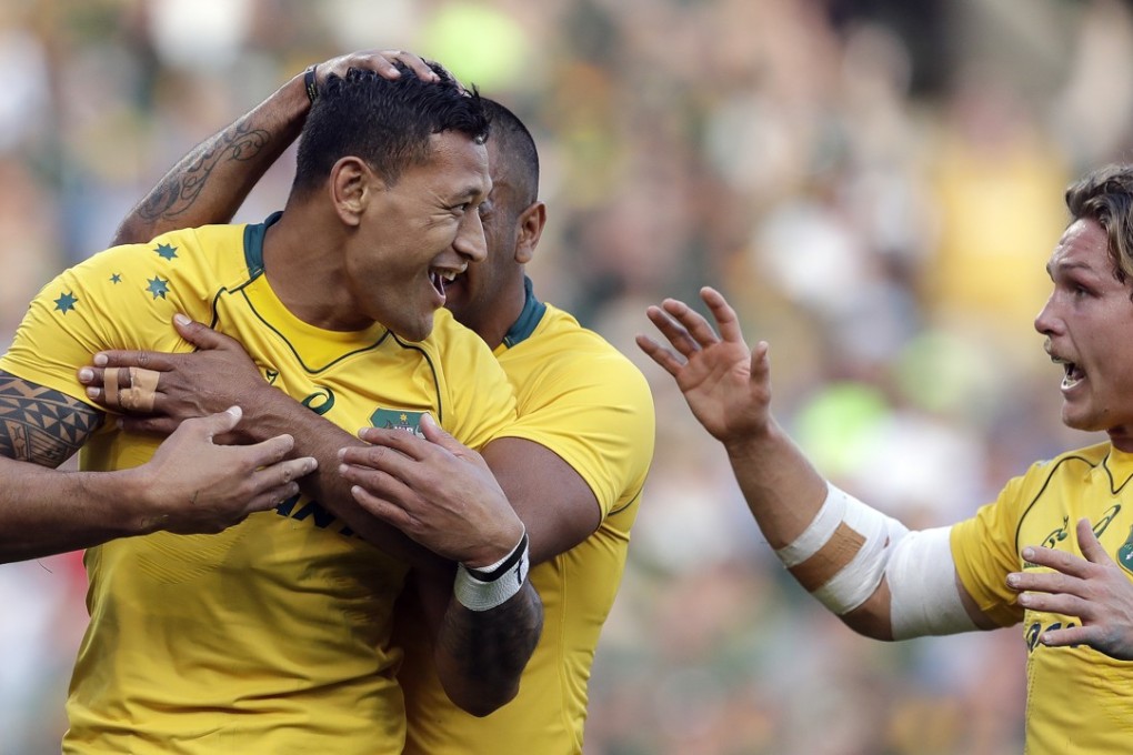 Australia’s Israel Folau is congratulated by teammates after scoring against South Africa in Bloemfontein. Photo: AP