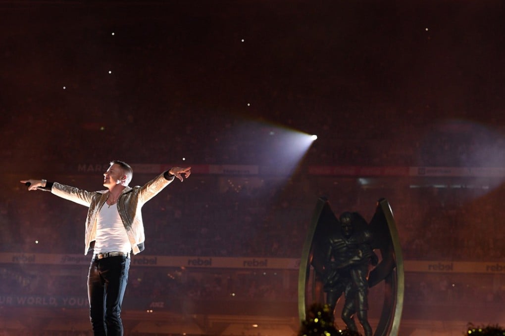 American rap artist Macklemore performs a gay anthem at a rugby league final in Sydney. Photo: EPA