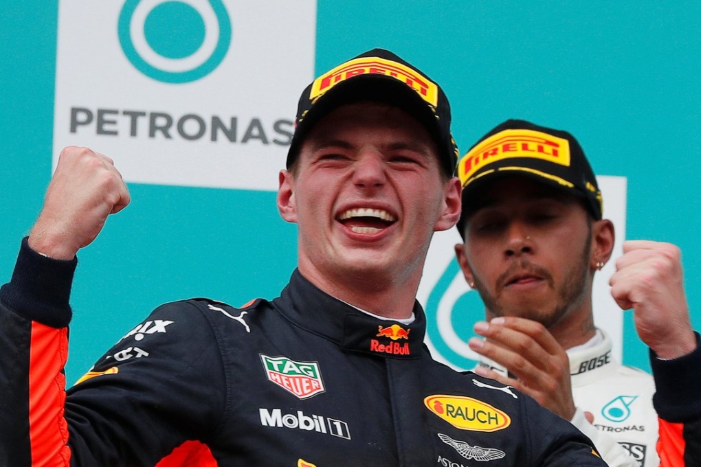 Red Bull's Max Verstappen celebrates on the podium with Lewis Hamilton after winning the final Malaysian Grand Prix. Photo: Reuters