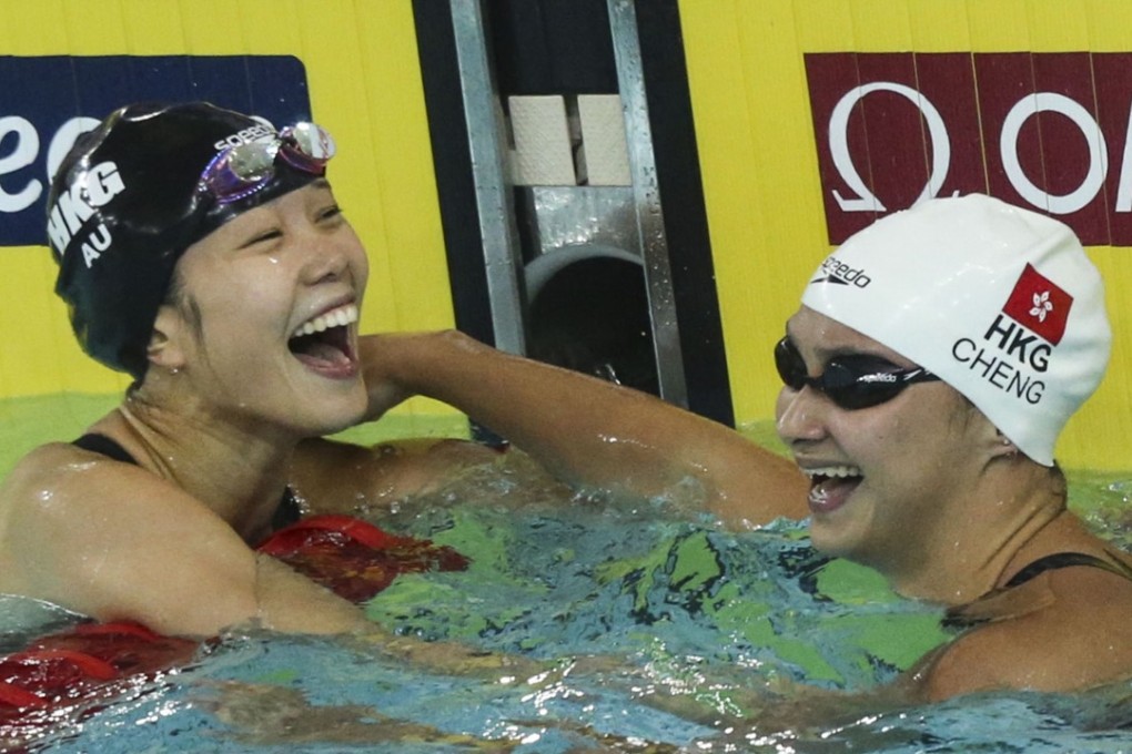 Stephanie Au Hoi-shun (left) is congratulated by teammate Camille Cheng after finishing fourth in the women's 50 metres freestyle in the World Cup at Victoria Park. Cheng finished sixth. Photo: Felix Wong