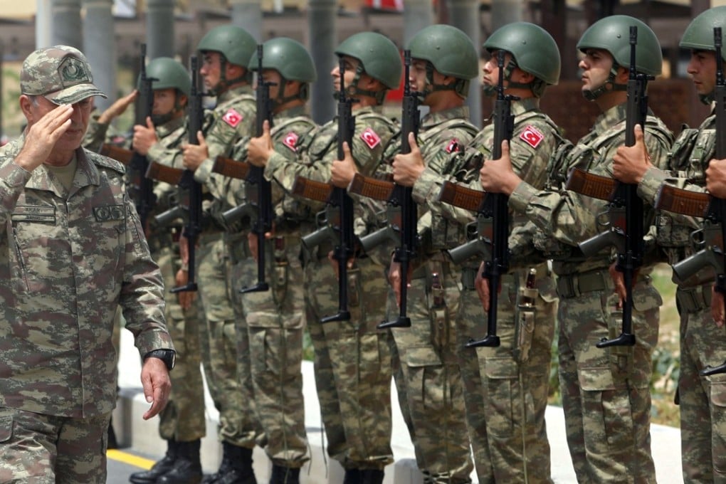 Turkish military chief of staff General Hulusi Akar salutes a guard of honour during the opening ceremony of a Turkish military base in Mogadishu, Somalia. Photo: Reuters