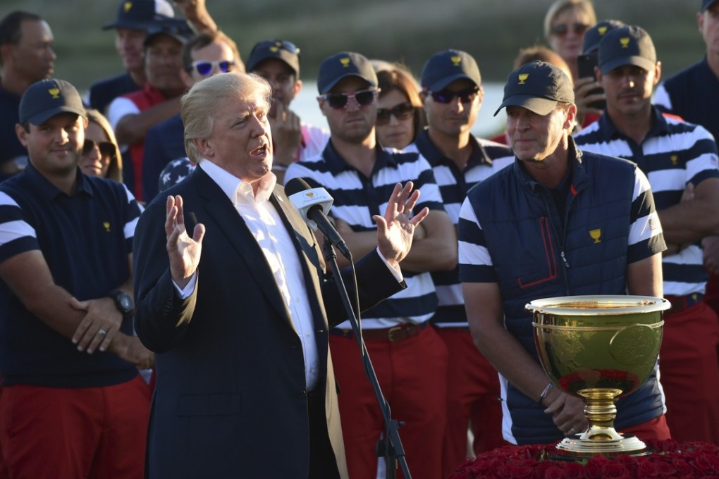 US President Donald Trump, standing with members of the United State team before presenting them with the Presidents Cup trophy at the Jersey City Golf Club on Sunday. Photo: AP