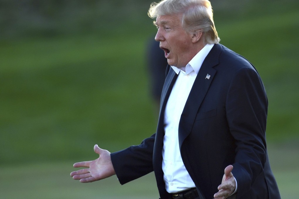 Donald Trump takes part in a ceremony to present the Presidents Cup to the US team at the Liberty National Golf Club in Jersey City, New Jersey, on Sunday. Photo: AP