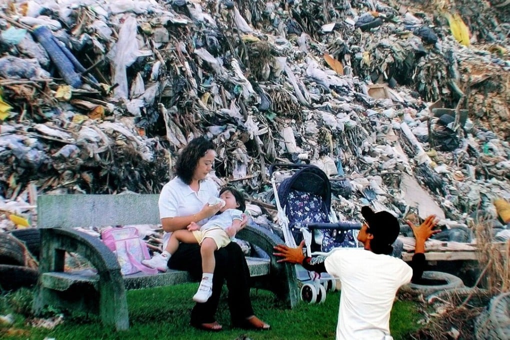 A worker gives a final touch-up on a huge recycling campaign poster during the first National Recycling Day at a Bukit Jalil Square in Kuala Lumpur, Malaysia. Photo: AP/Teh Eng Koon