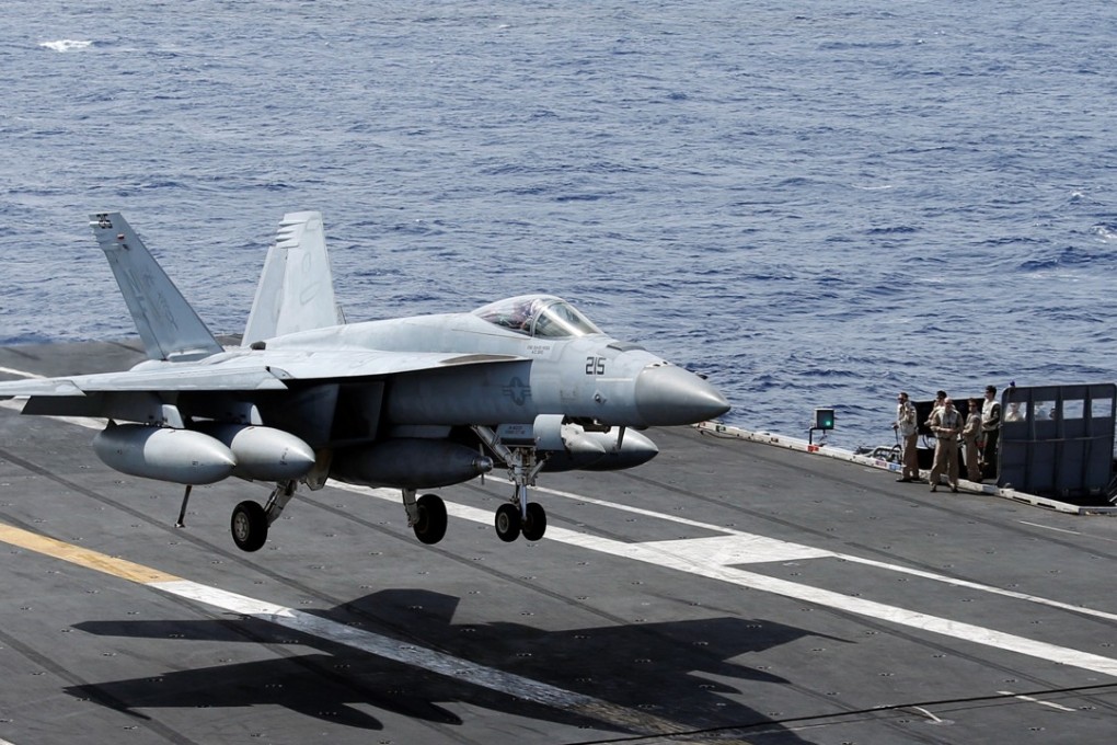An F/A-18 Super Hornet lands on the deck of the USS Ronald Reagan in the South China Sea. Photo: Reuters