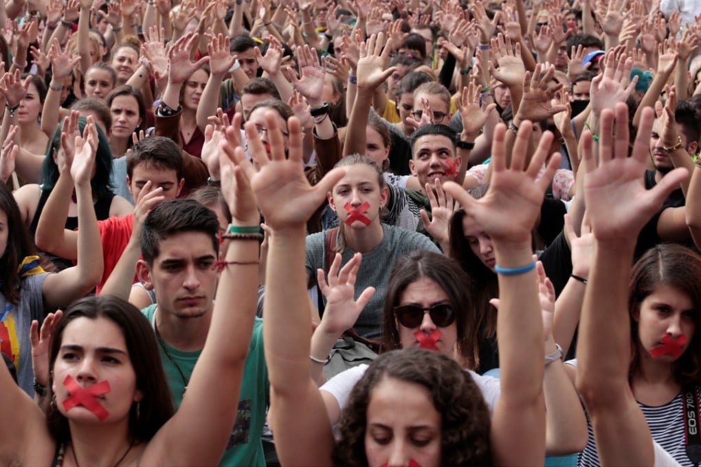 People raise their hands during a protest the day after the banned independence referendum in Barcelona. Photo: Reuters
