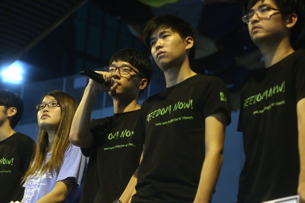 Activist Nathan Law (with microphone) is one of a few pro-democracy names Robert Pang will represent in court. Photo: Sam Tsang