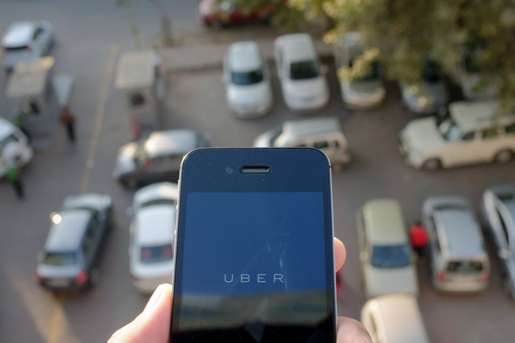 The Uber smartphone app is pictured over a parking lot in the Indian capital New Delhi. Rival Ola has received US$2 billion in new funding from Softbank and Tencent. Photo: AFP