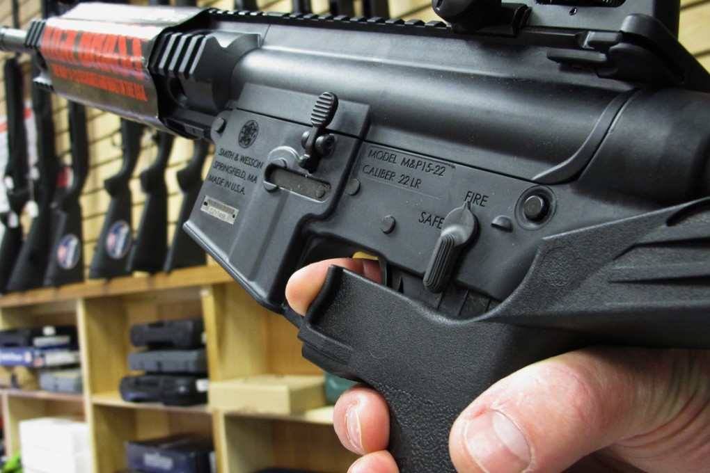 A gun shop worker demonstrates how a ‘bump’ stock works. Photo: AP