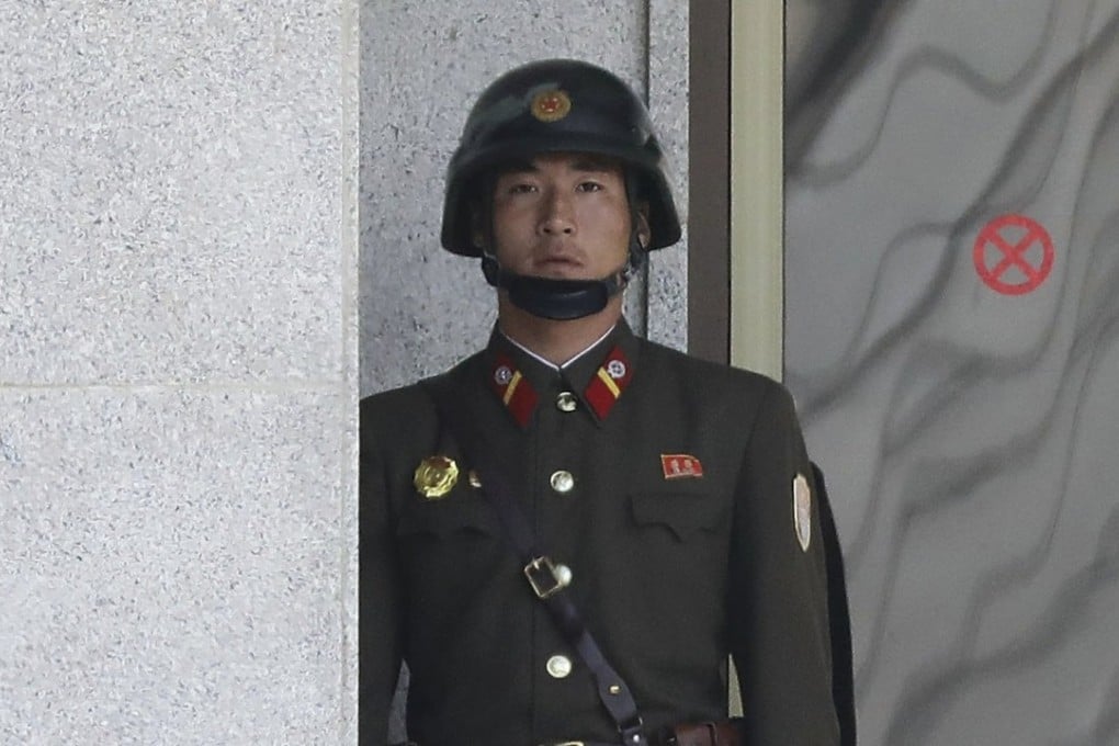 A North Korean soldier looks at South Korea across the Korean Demilitarised Zone as seen from Panmunjom, South Korea. Photo: EPA