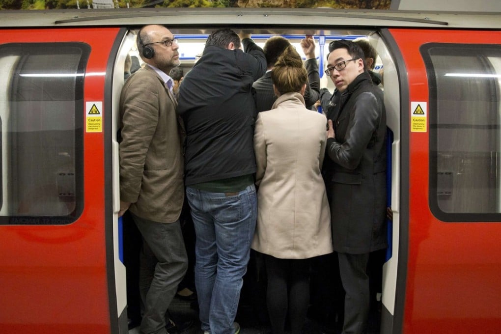 Commuters board the London Tube. Photo: Reuters
