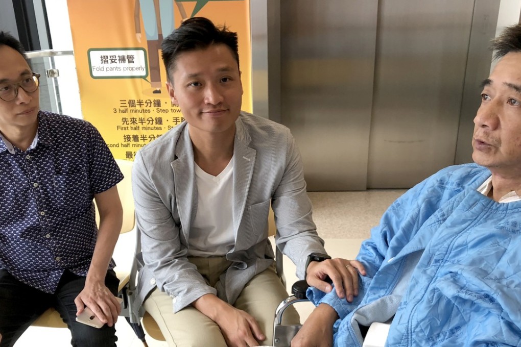 Sham Shui Po district councillor Vincent Cheng Wing-shun (centre) visits a bus passenger surnamed Wong (right), who remained in hospital after sustaining injuries in the September 22 crash. Photo: Handout