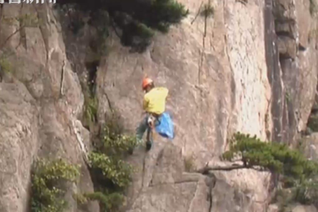 Cleaning staff abseil down the cliffs to pick up litter left by visitors. Photo: App.peopleapp.com