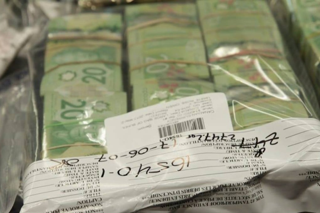 Stacks of cash seized as part of the Project Enationalize police operation are displayed at a June press conference in Vancouver, Canada. Xing Wei had a 7kg bag of stacked C$20 notes, worth C$140,000, when he was arrested Photo: Police handout / BC CFSEU