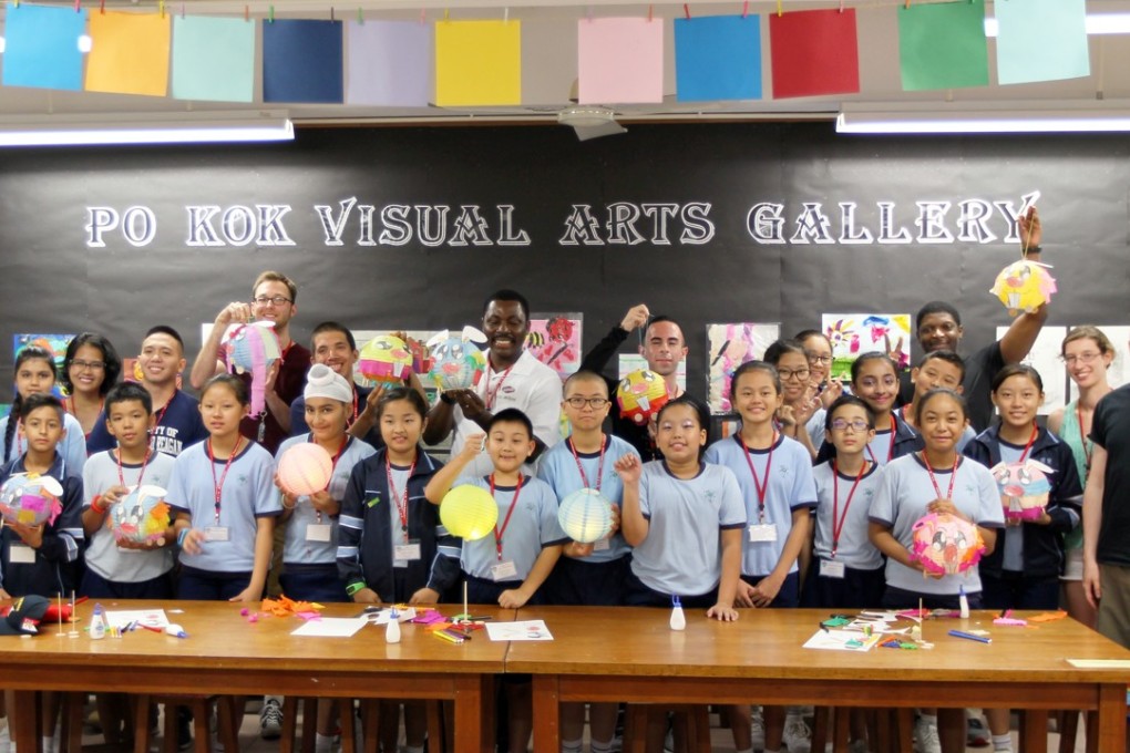 Visitors from the USS Ronald Reagan and USS Chafee with pupils at Po Kok Primary School in Happy Valley. Photo: Roy Issa
