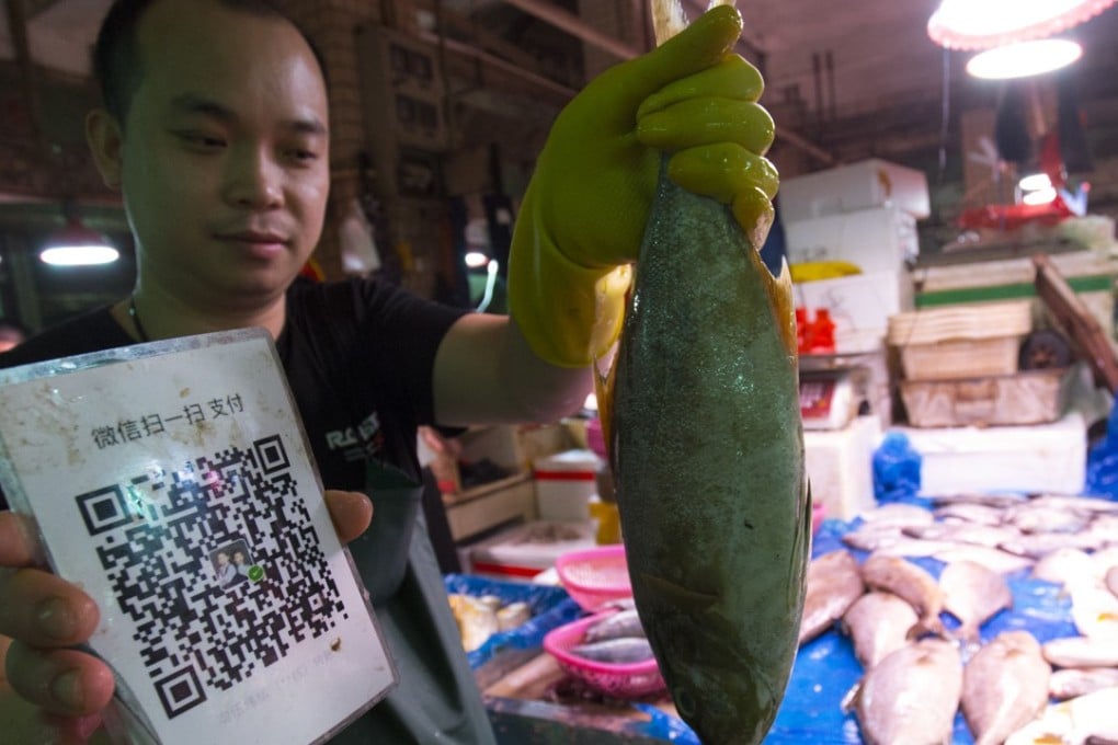Even fish vendors in China’s wet markets accept mobile payments. Photo: May Tse