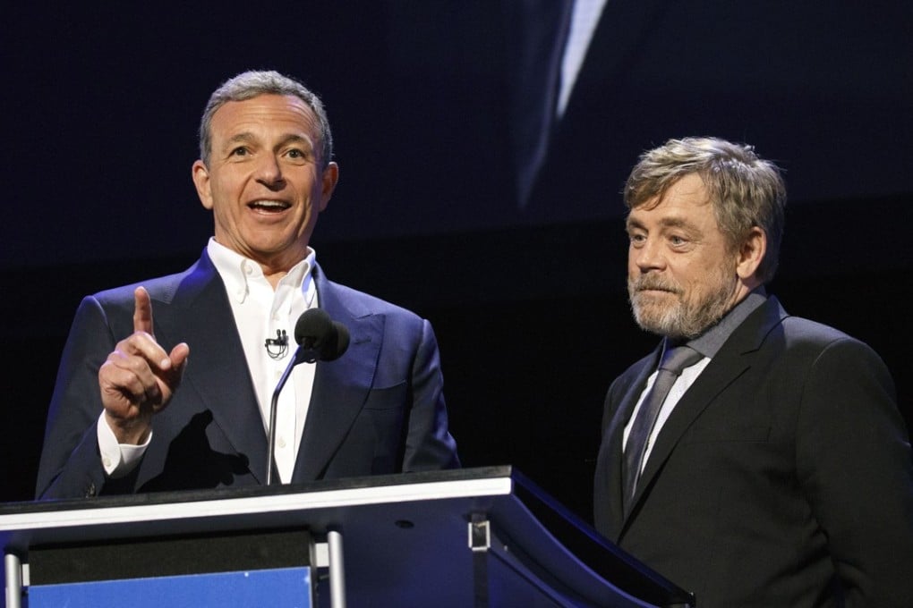 Bob Iger, chairman and chief executive officer of The Walt Disney Co., left, speaks on stage with actor Mark Hamill during the Disney Legends Awards at the D23 Expo 2017 in Anaheim, California, U.S. Photo: Patrick T. Fallon/Bloomberg