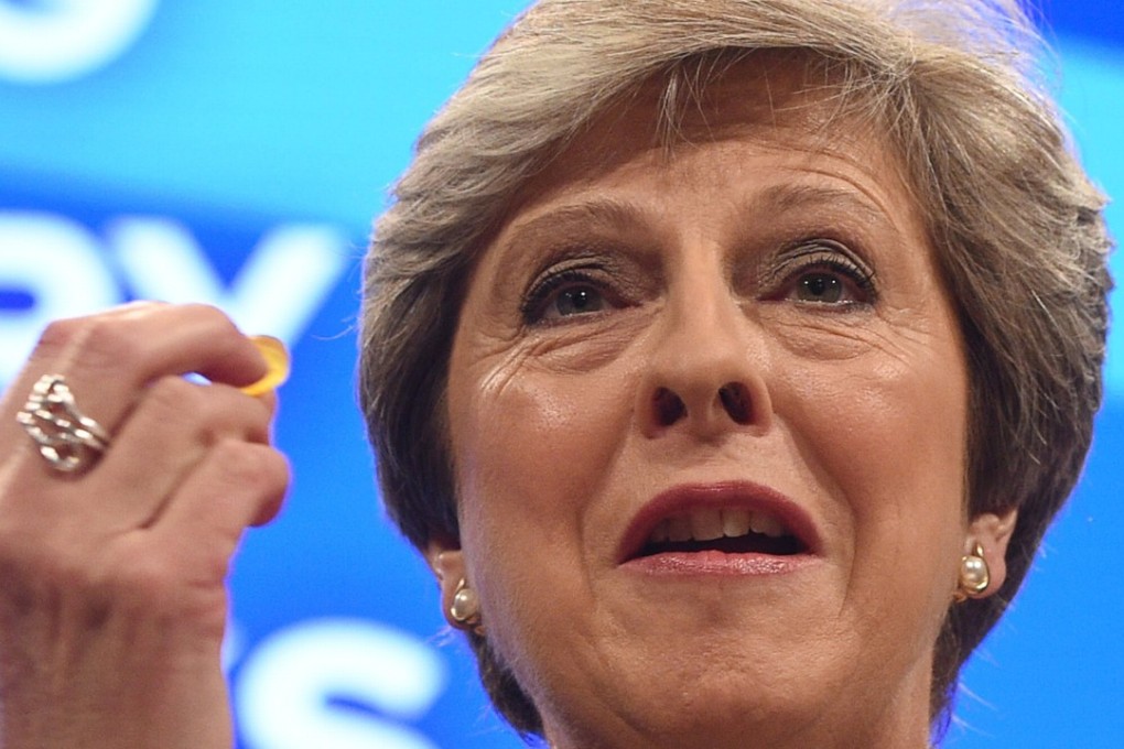 British Prime Minister Theresa May holds cough lozenge while delivering her speech on the final day of the Conservative Party conference in Manchester. Photo: EPA