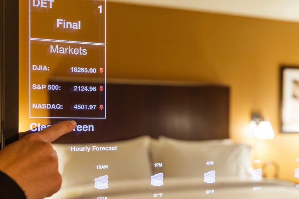 A “smart” mirror in use at a Sheraton hotel. Smart mirrors in the rooms will enable guests to check stock, read news headlines and check the weather on touch screen mirrors. Photo: SCMP Handout