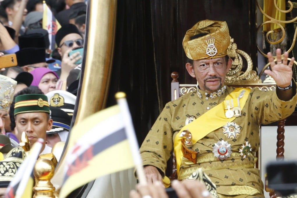 Brunei's Sultan Hassanal Bolkiah waves to well-wishers during a procession as part of the Golden Jubilee celebrations in Bandar Seri Begawan. Photo: EPA
