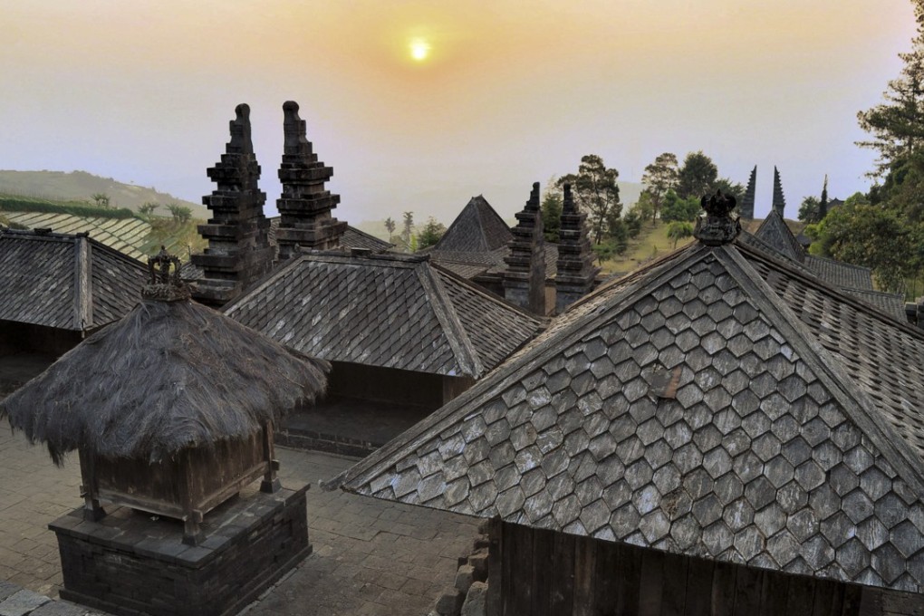 The sun sets over the ancient Candi Cetho Hindu temple in Solo, Indonesia. Photo: Alamy