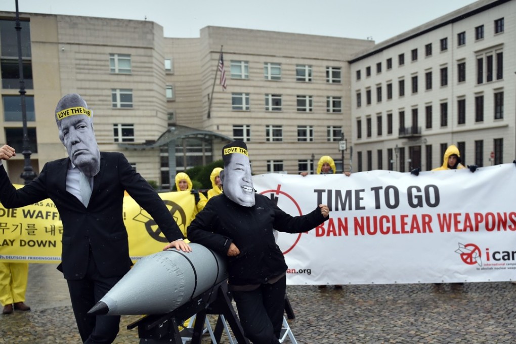 Activists from ICAN wearing masks of US President Donald Trump and North Korea's leader Kim Jong-un as they demonstrate in front of the US embassy in Berlin, calling for nuclear weapons to be banned. Photo: AFP