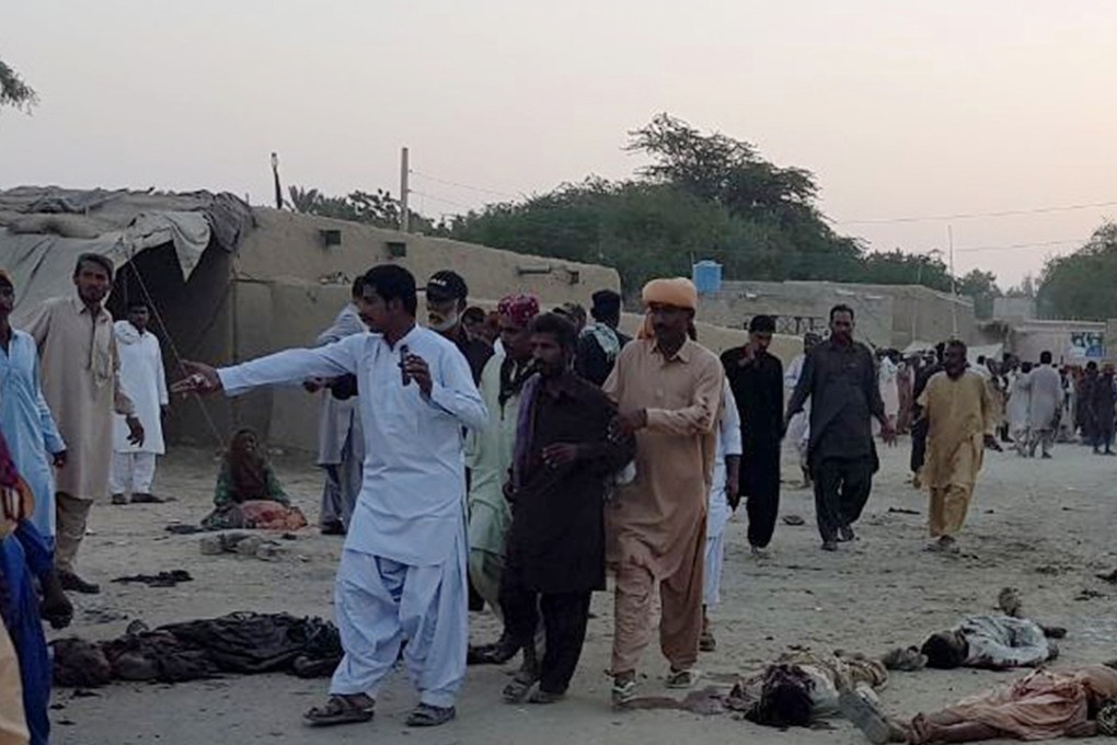 People gather at the blast site in southwest Pakistan where scores were killed in a suicide bomb attack. Photo: Xinhua