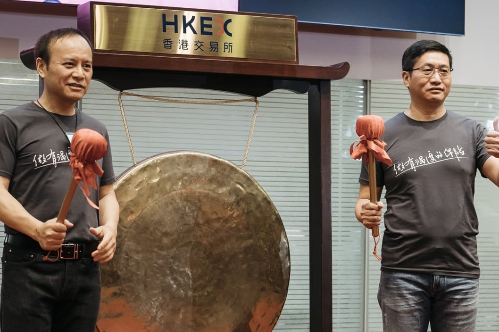 Yaping Ou, chairman of Zhongan, left, and Chen Jin, chief executive officer, pose for a photograph during the company's listing ceremony at the Hong Kong Stock Exchange in Hong Kong on Thursday September 28. Its shares have gained 60 per cent since trading started last Thursday. Photo: Bloomberg