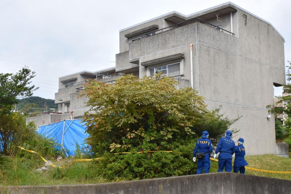 Investigators work near a flat which was engulfed by a fire in Hitachi, Ibaraki prefecture. Photo: Kyodo