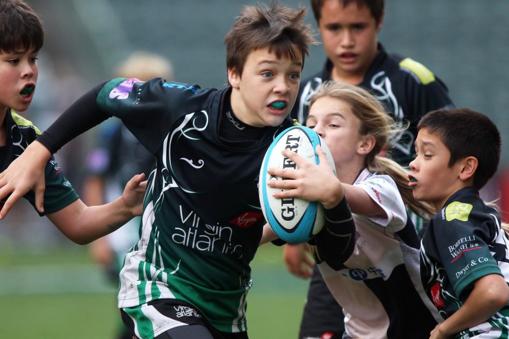 Hong Kong kids in action at the Sevens – but if some parents get there way, “harmful contact” would be banned from youth rugby. Photo: Nora Tam