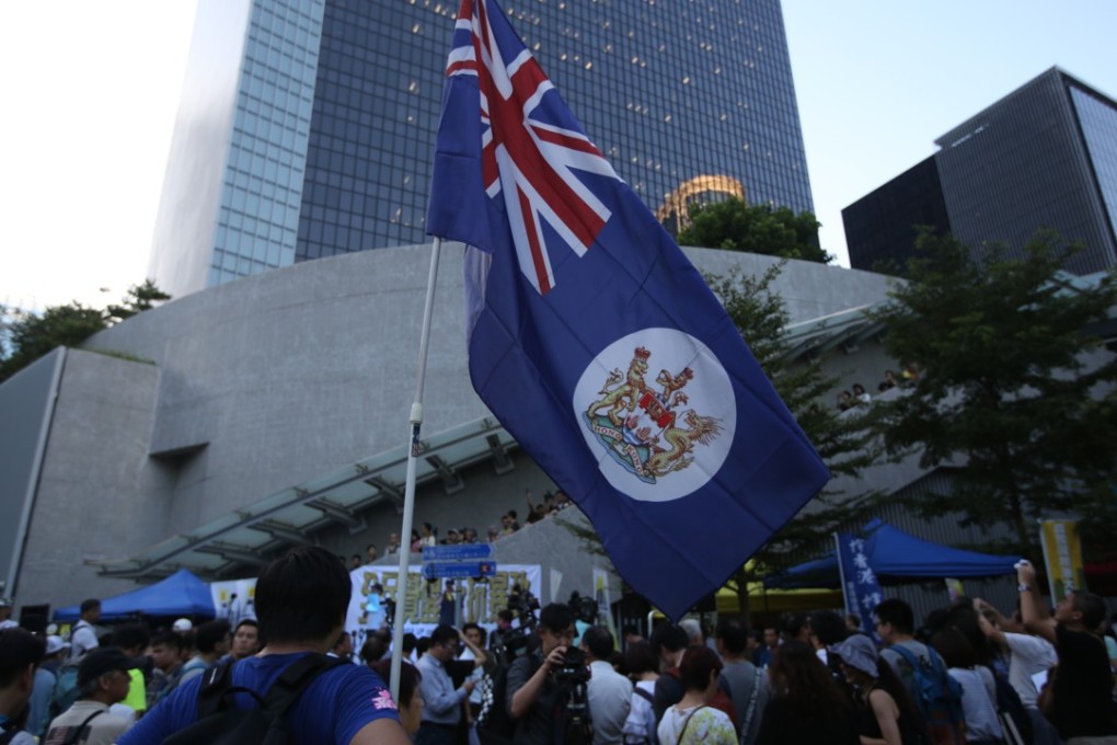 A protester holds up a colonial Hong Kong flag during a rally to commemorate the 2014 Occupy movement. Photo: Sam Tsang