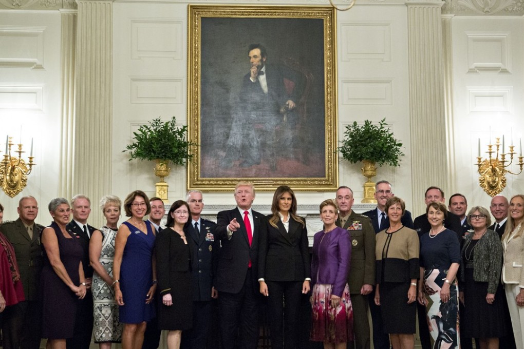US President Donald Trump and First Lady Melania Trump pose for an official photograph with senior military leaders and their spouses in the State Dining room of the White House on Thursday. Photo: Bloomberg